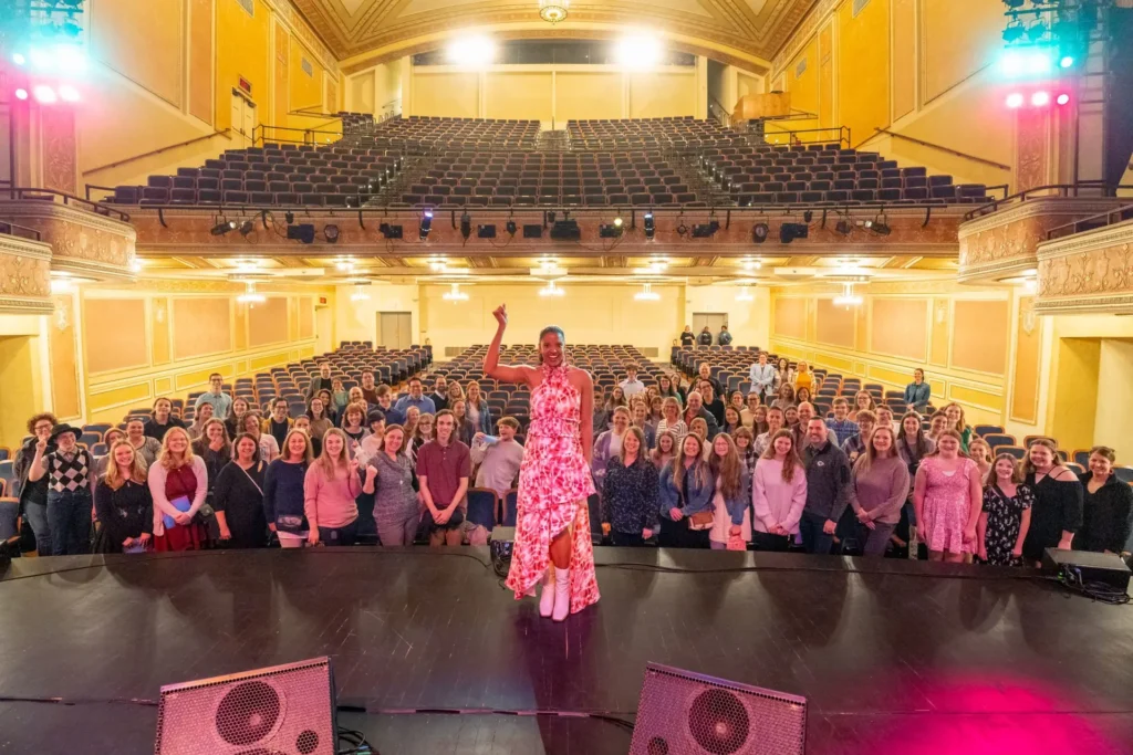 The crowd poses with Tony Award- winning actress and Broadway star Renee Elise Goldsberry.